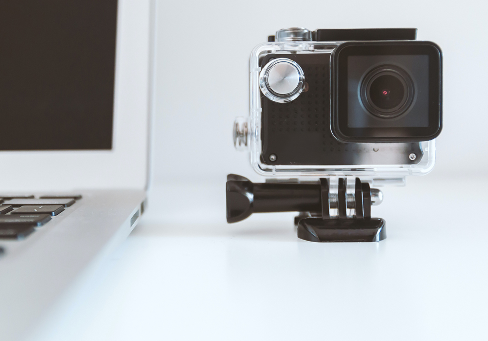 camera beside a laptop