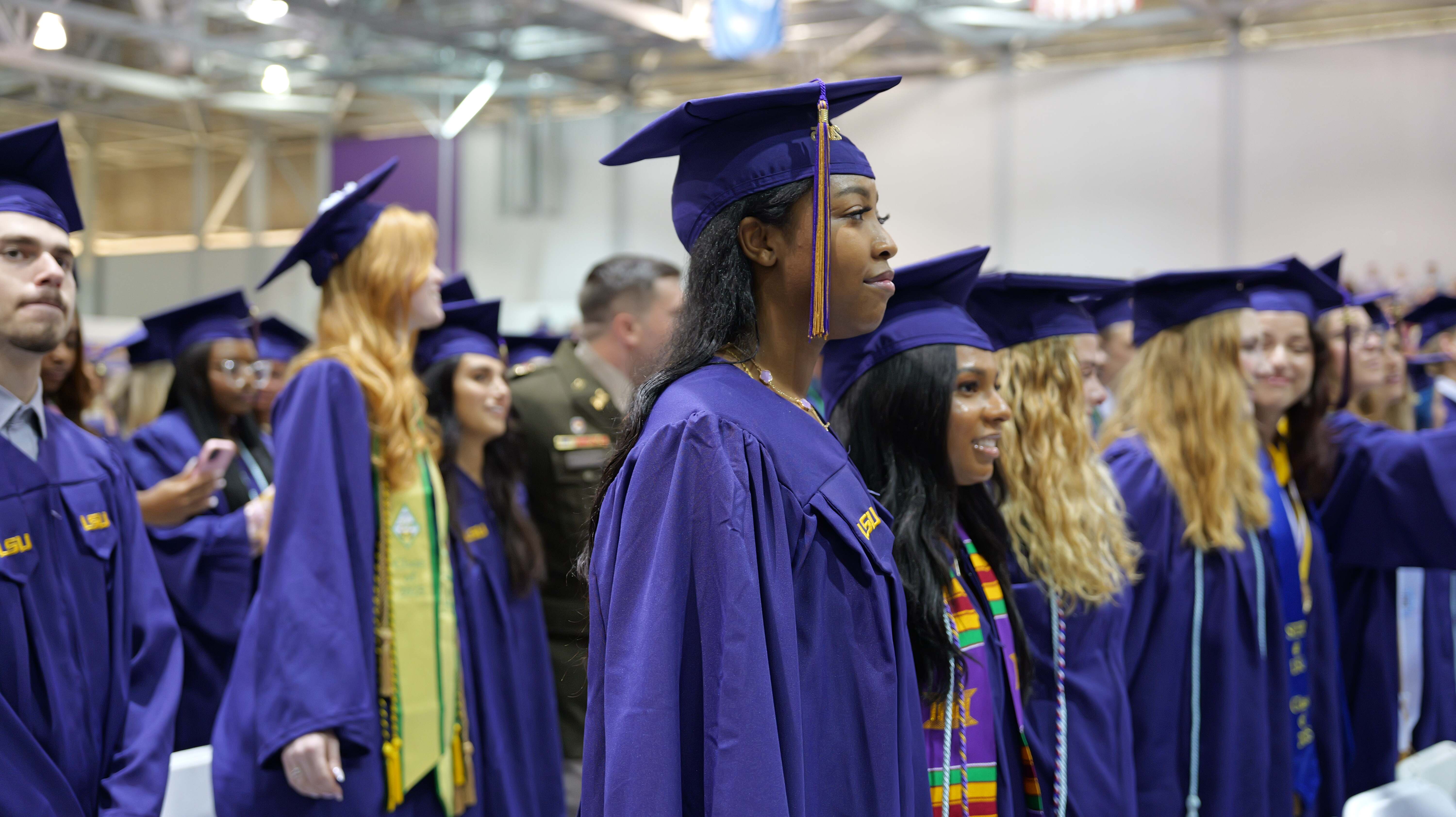 Students standing, ready to turn their tassles to the other side Placeholder Image