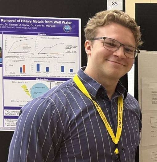 Paul Labbe stands in front of a research poster at LSU Discover Day 2023