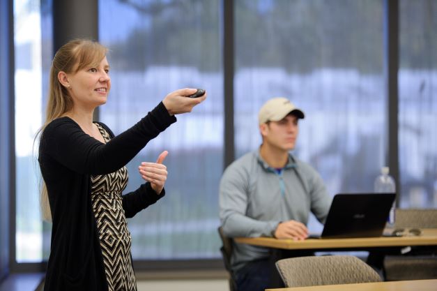 PhD student teaches in classroom.