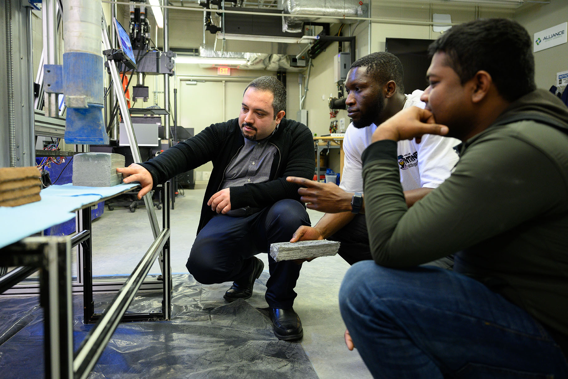 Professor and students working with concrete