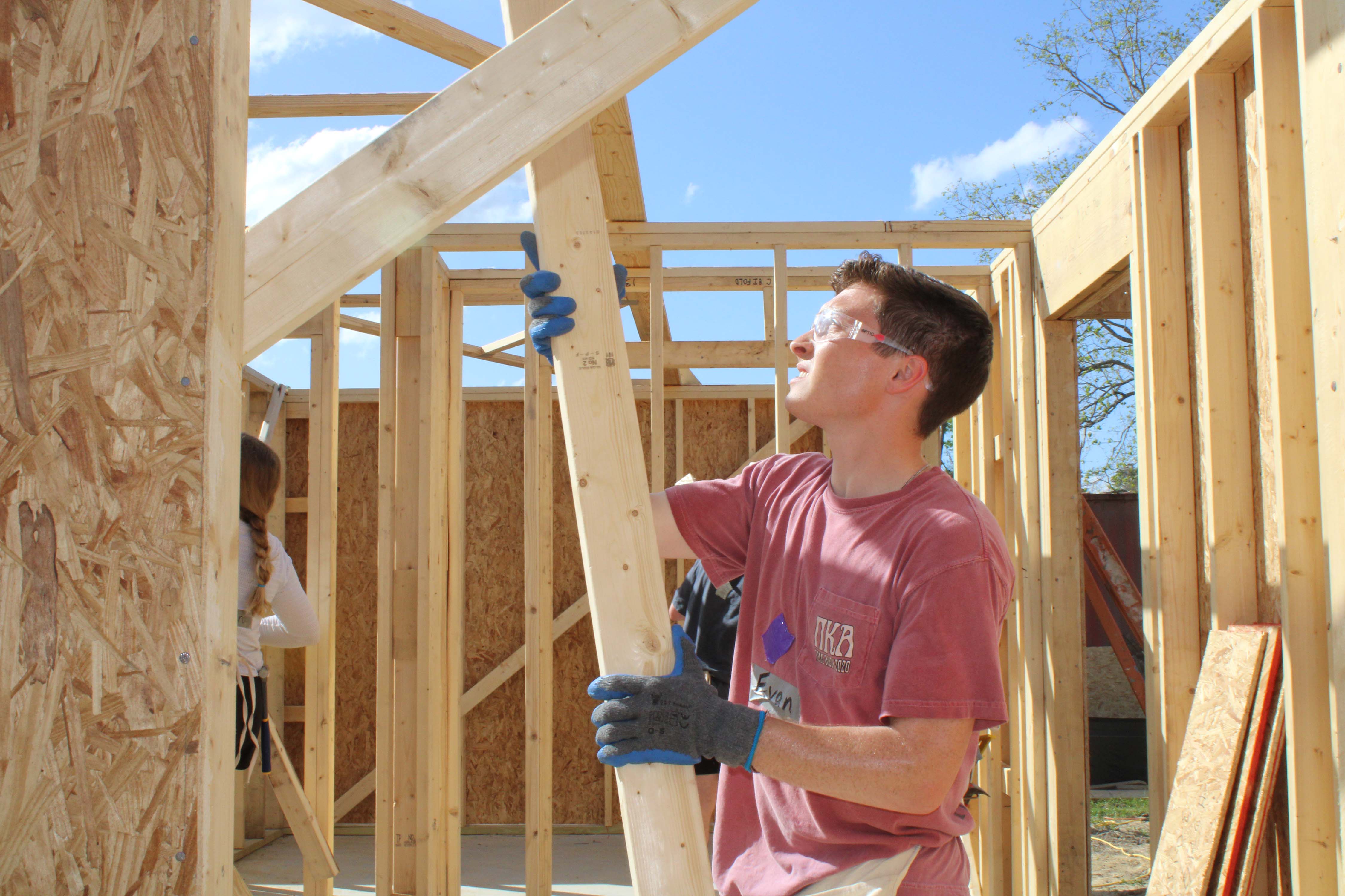 fraternity member hammering volunteering at Greek Week