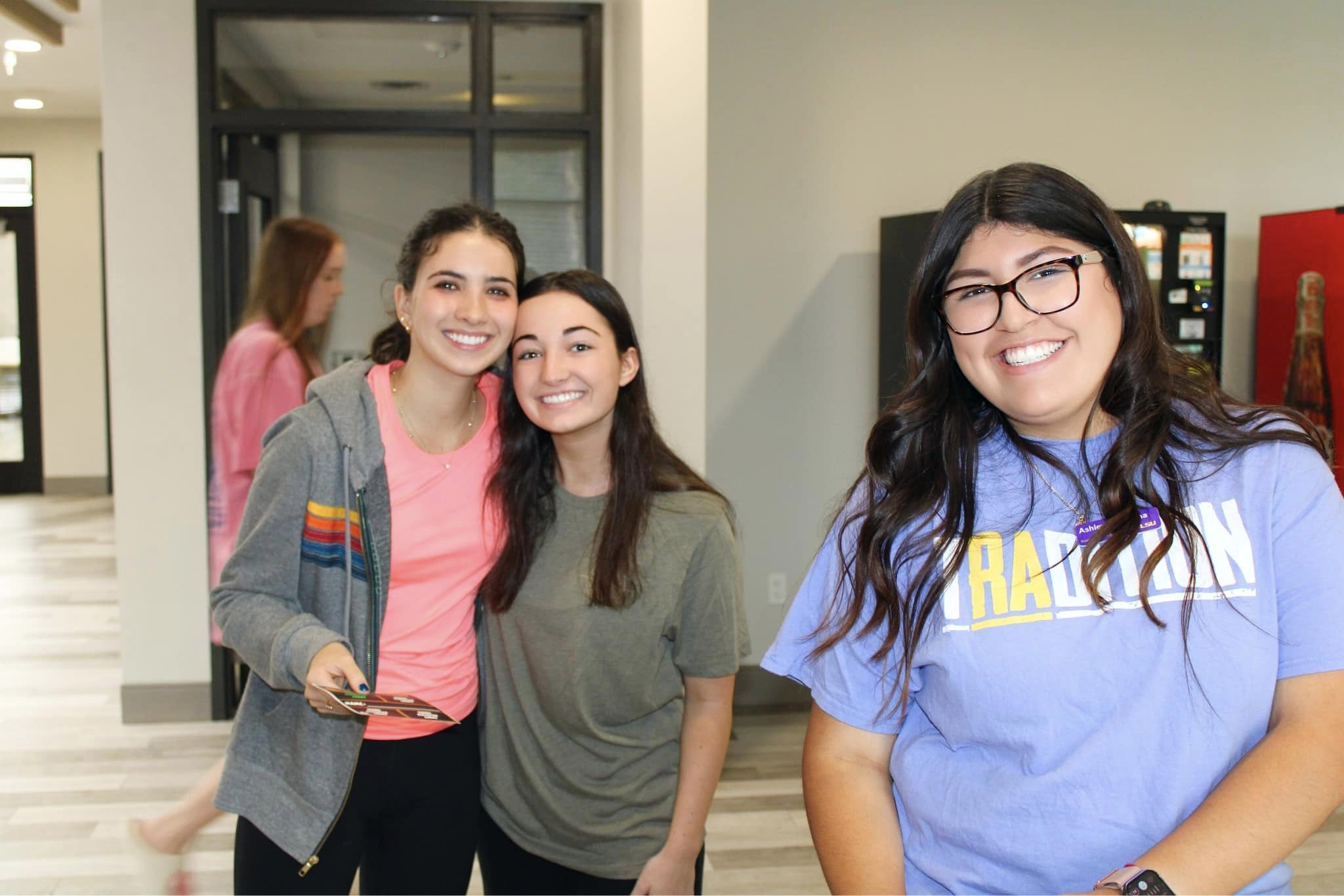 two students posing for a photo with a resident assistant