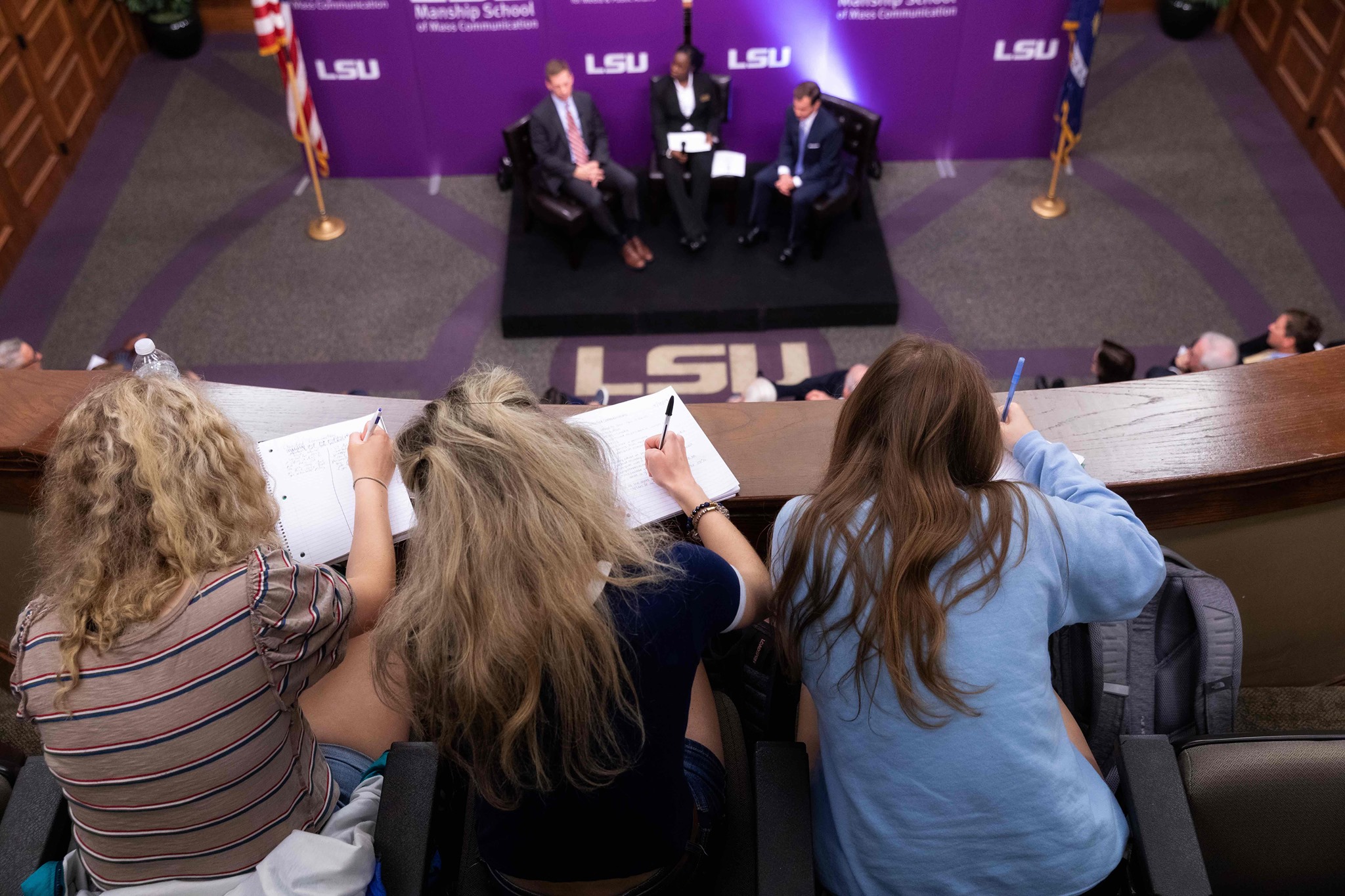 Students taking notes at Reilly Center event in the Forum