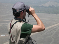 man looking through binoculars