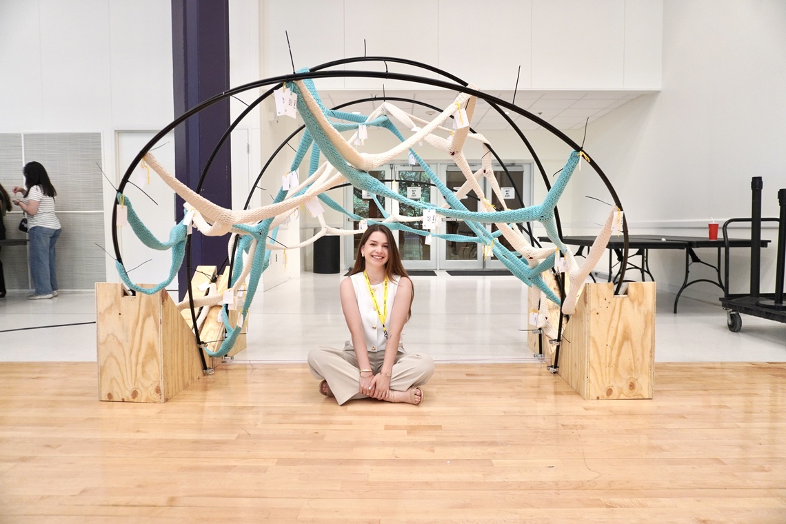 Student with their art installation project