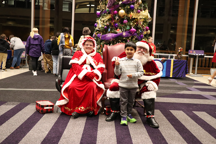 child with Santa and Mrs. Claus