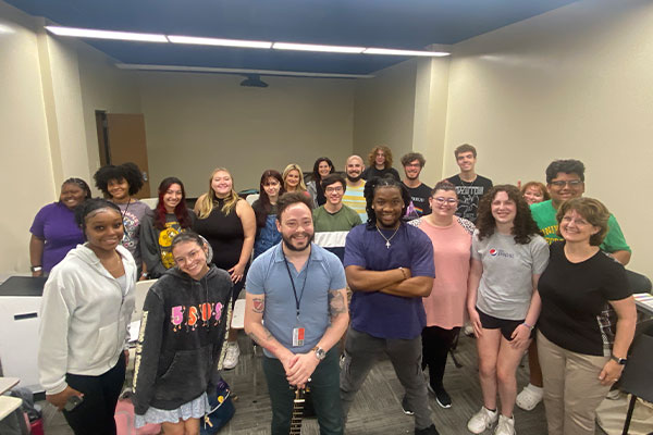 Charlie Rauh in rehearsal room with choir